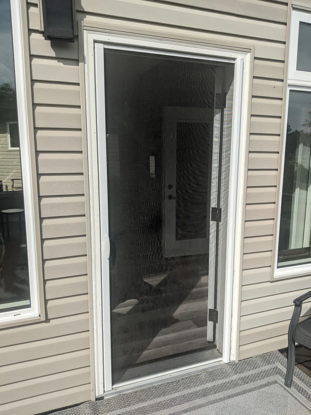 Mirage retractable screen installed on single entry door — screen extended