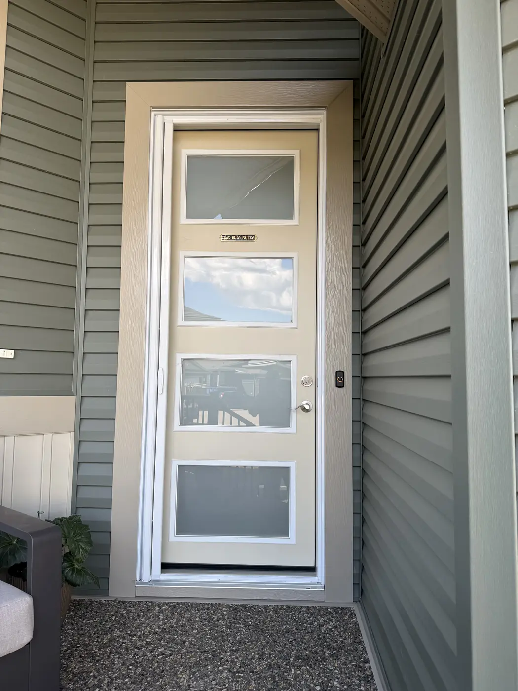 Four-panel modern entry door with Mirage retractable screen extended across the doorway