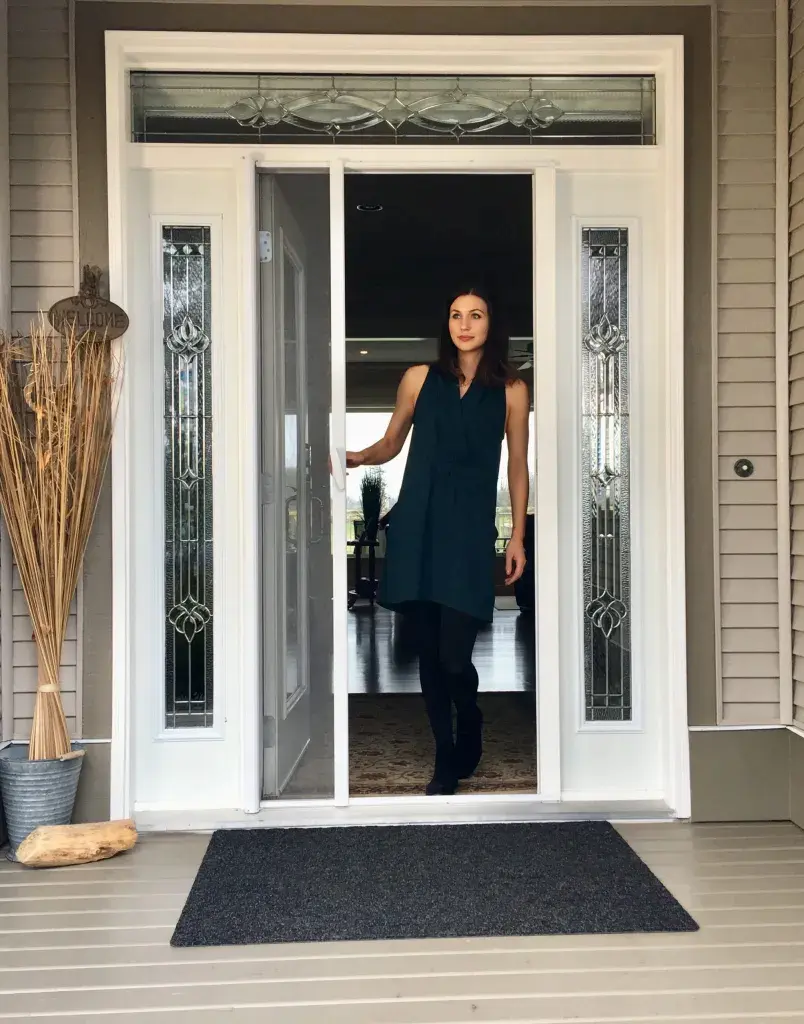 Woman walking through front entry with retractable screen